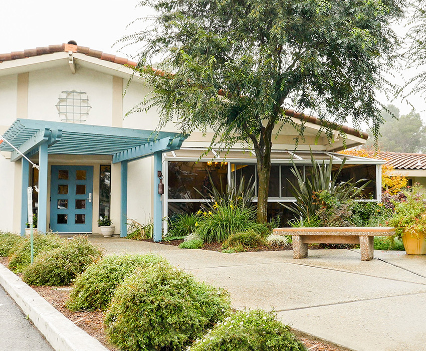 The front of the Pacific Coast facility, green tree and shrubs